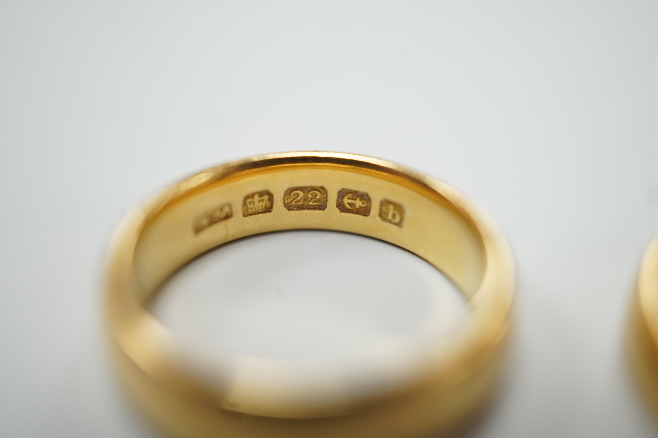 A thin Victorian 22ct gold wedding band, London, 1875, size K/L and two later 22ct gold wedding bands, including Edwardian (1901), size I, and Elizabeth II (1969), size N, 11.1 grams.